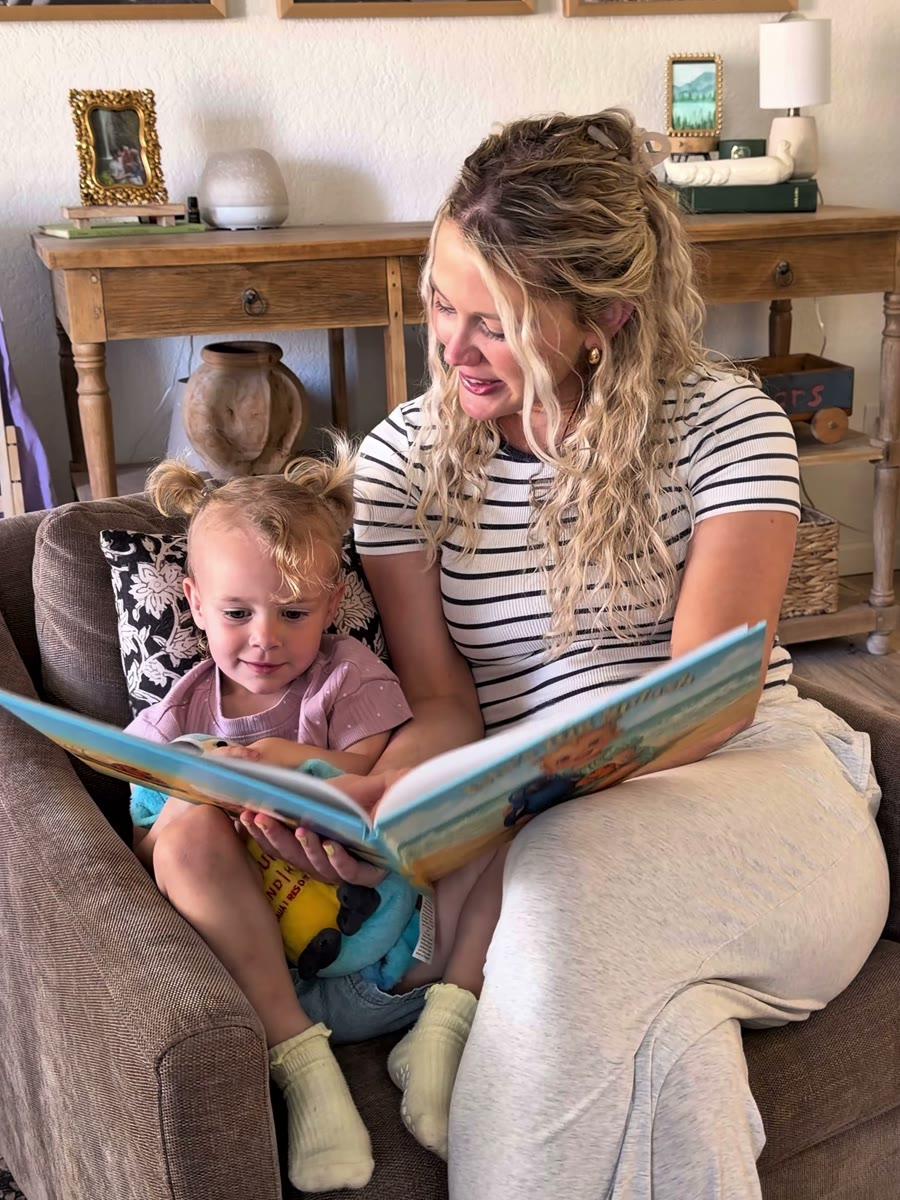 A mom and her little girl reading their personalized PlotJoys storybook together